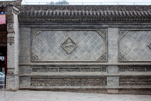 Traditional Chinese Wall With Details Of Glazed Green And Grey Tiles.