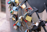 Love locks hang from bridge in Prague representing secure friendship and romance. Padlocks of lovers on bridge as symbol of connection, partnership, loyalty and love. Saint valentines day background.