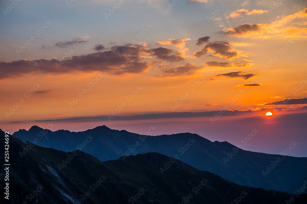 Beautiful landscape with high mountains , blue sky and yellow sunlight in sunrise.