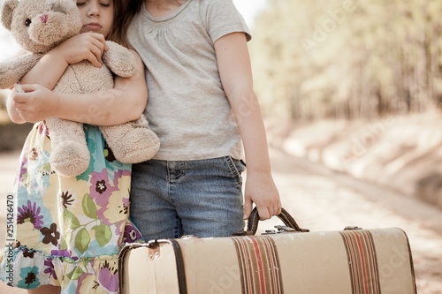 фотографія Little Girls Alone on Dirt Road with Teddy Bear and Suitcase - Homelessness, Pov
