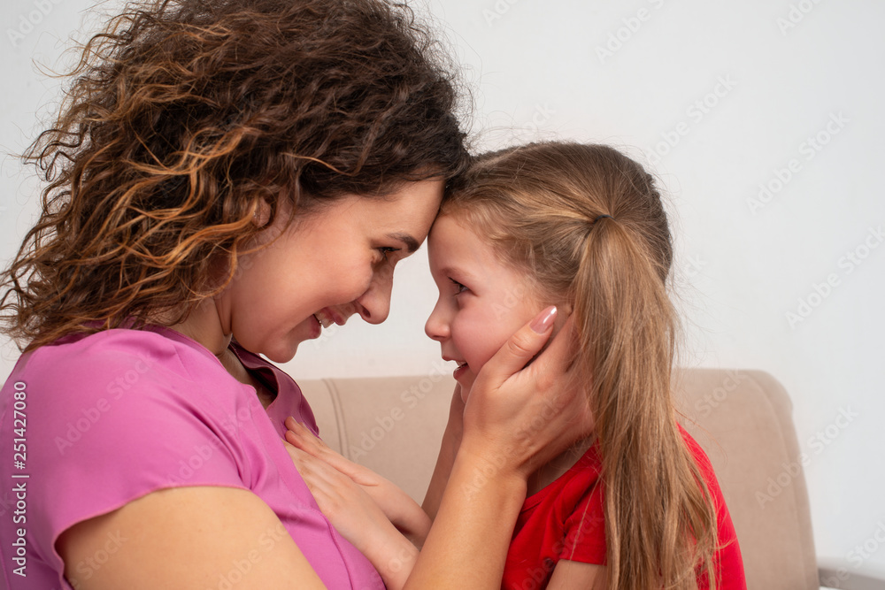 Shot of a cherriful young mother lovinfly embracing her little daigher Shot of a cherriful young mother lovinfly embracing her little daigher