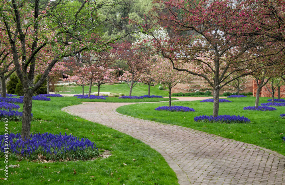 Spring Flowering Trees and Flowers Along a Brick Path