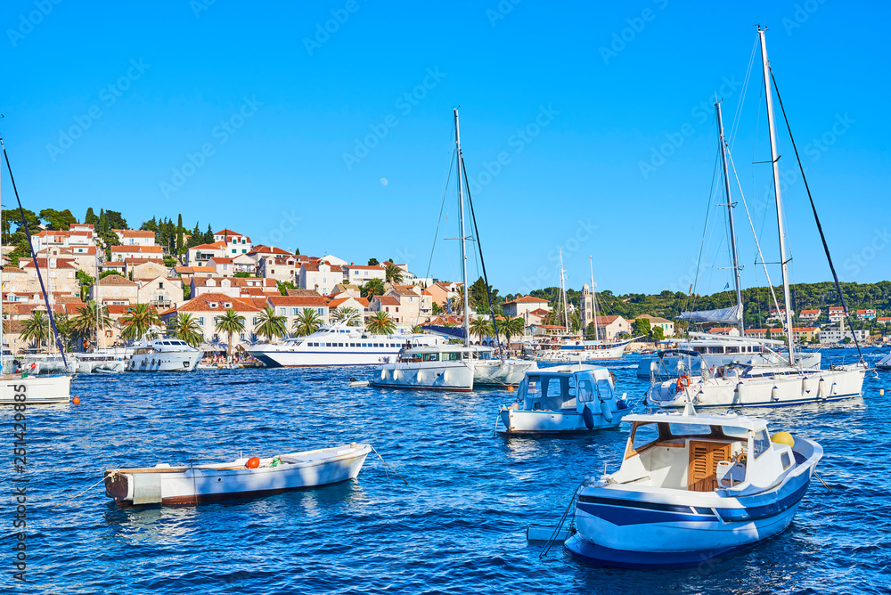 Luxury yachts, ships and fishing boats moored in harbor Hvar, Croatia