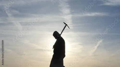 black ancient hoodie human with pickaxe horizontal motion silhouette photo