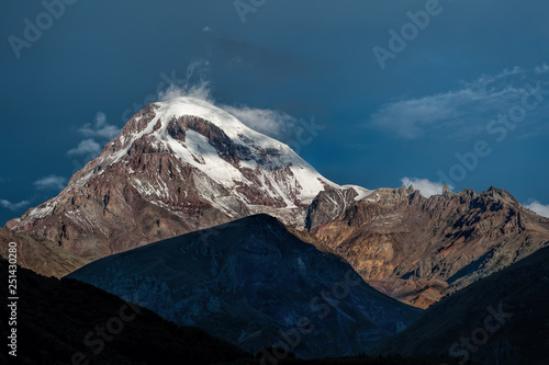 Kazbek mountain in the light of the rising sun photo