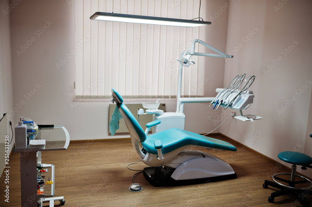 Dental chair by dentists in blue with medic light. Modern dental practice. Dental chair by dentists in blue with medic light. Modern dental practice.