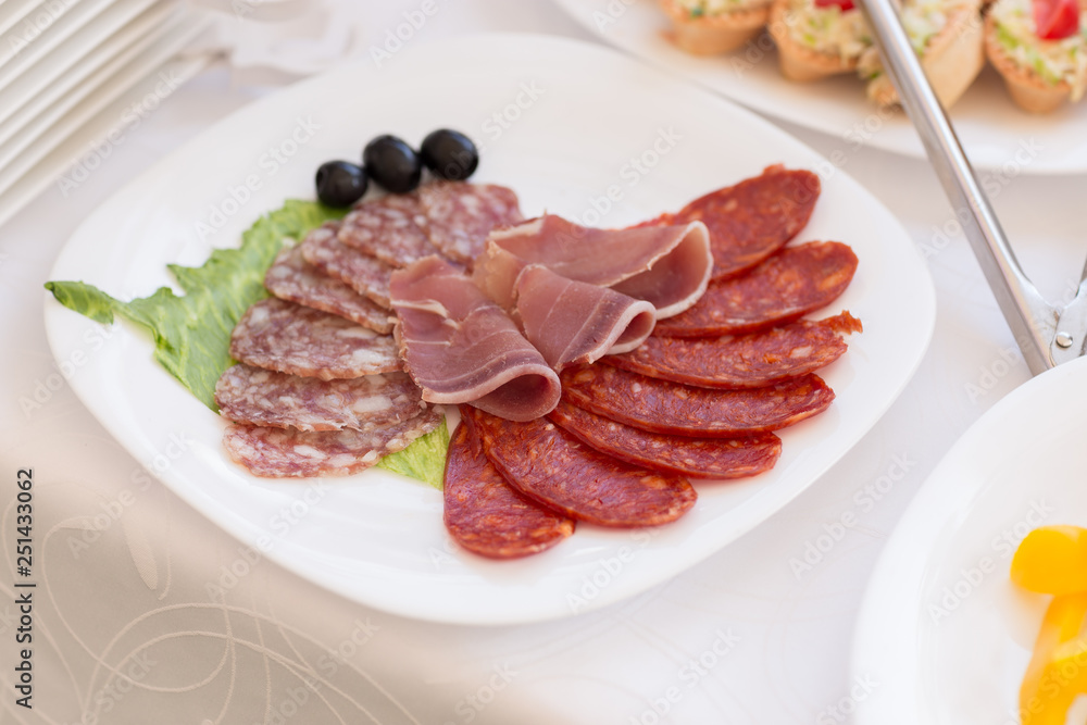slices of salami and meat on the festival table