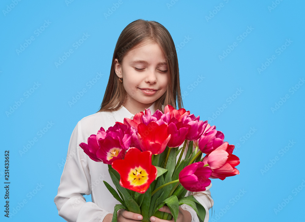 Little girl with colorful tulips on blue background Little girl with colorful tulips on blue background
