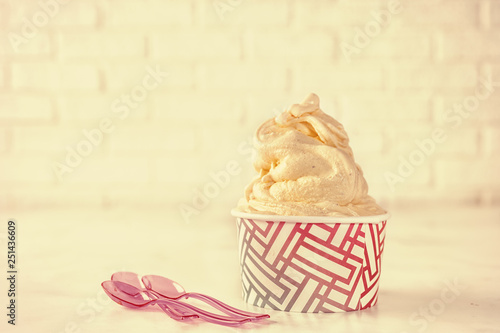 Retor toning. Soft ice cream in paper cup on white background