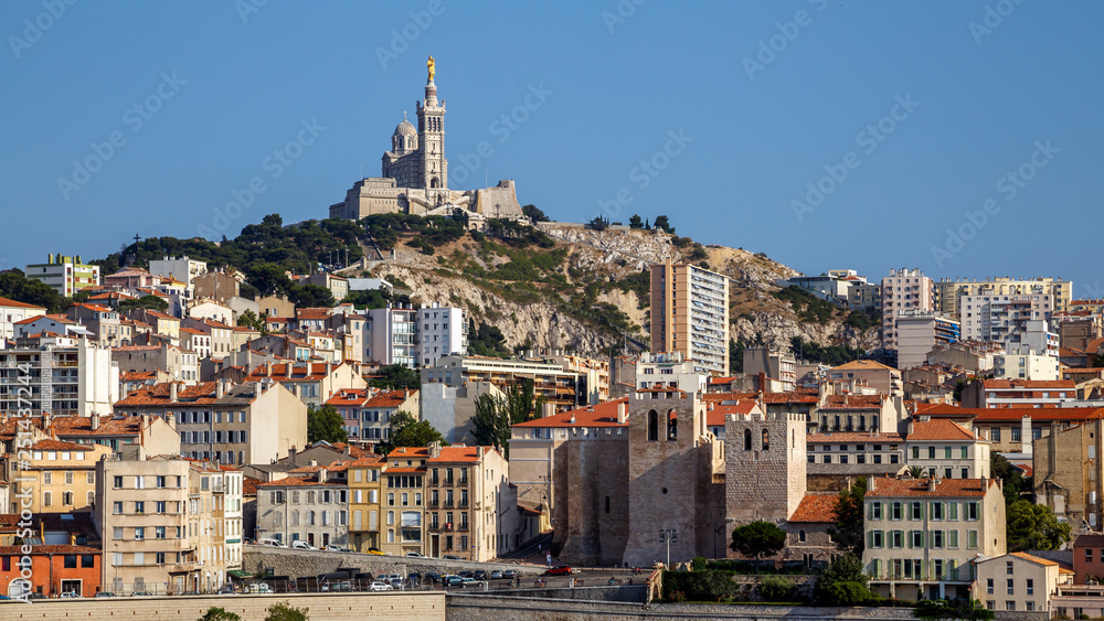 Panoramic cityscape of Marseille with the church Notre-Dame de la Garde, landmark of the city,  on a hilltop. Marseille, Provence, France. Holidays in France.