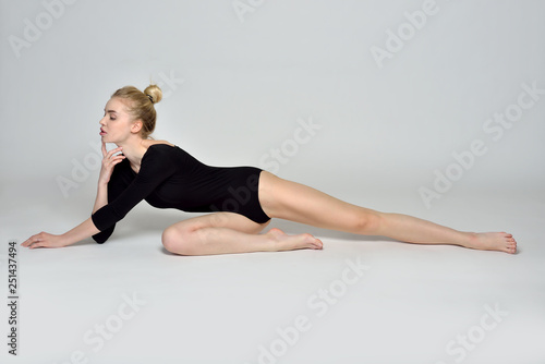 gymnast barfoot woman is sitting on the floor in studio photo