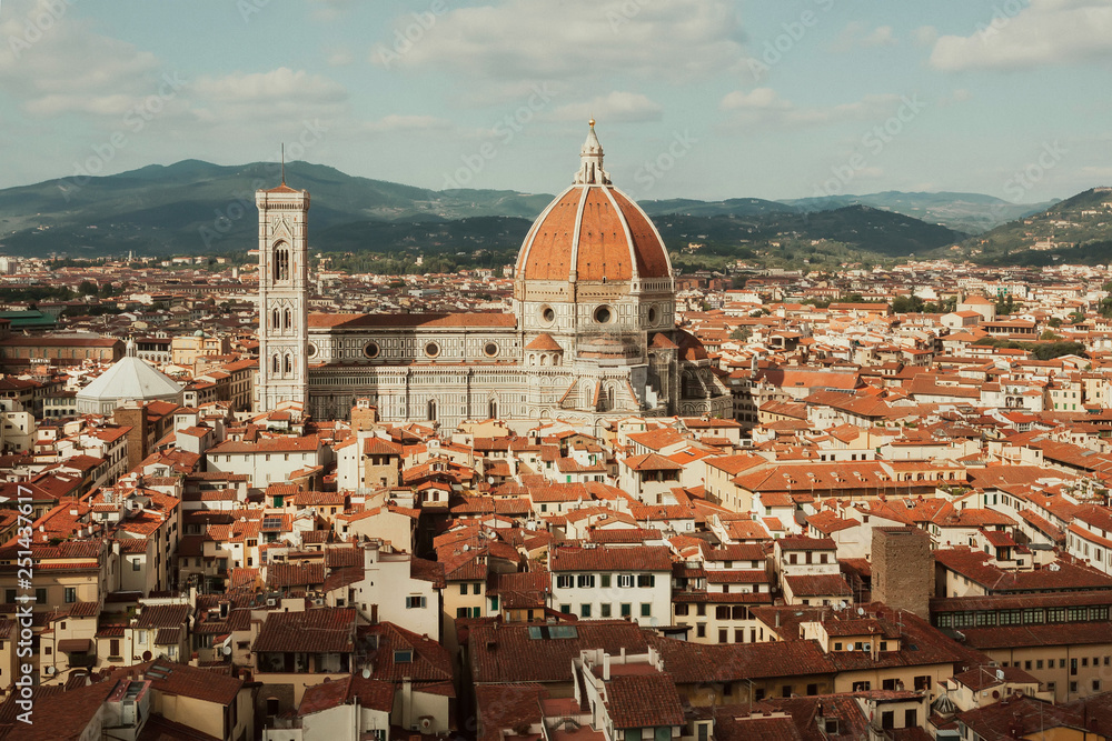 Florence cityscape. Red tile roofs and 14th century Duomo in historical area, Italy