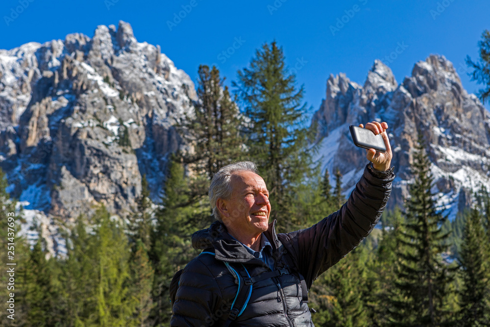 Man taking selfie at Tre Cime di Lavaredo, Italy Man taking selfie at Tre Cime di Lavaredo, Italy