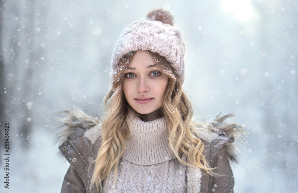 Portrait of young woman in woolly hat under snowfall Portrait of young woman in woolly hat under snowfall