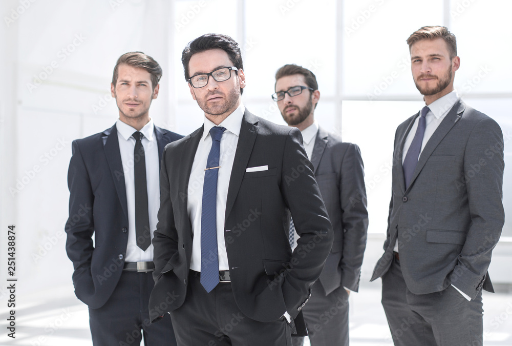 businessman and his business team standing in the office businessman and his business team standing in the office