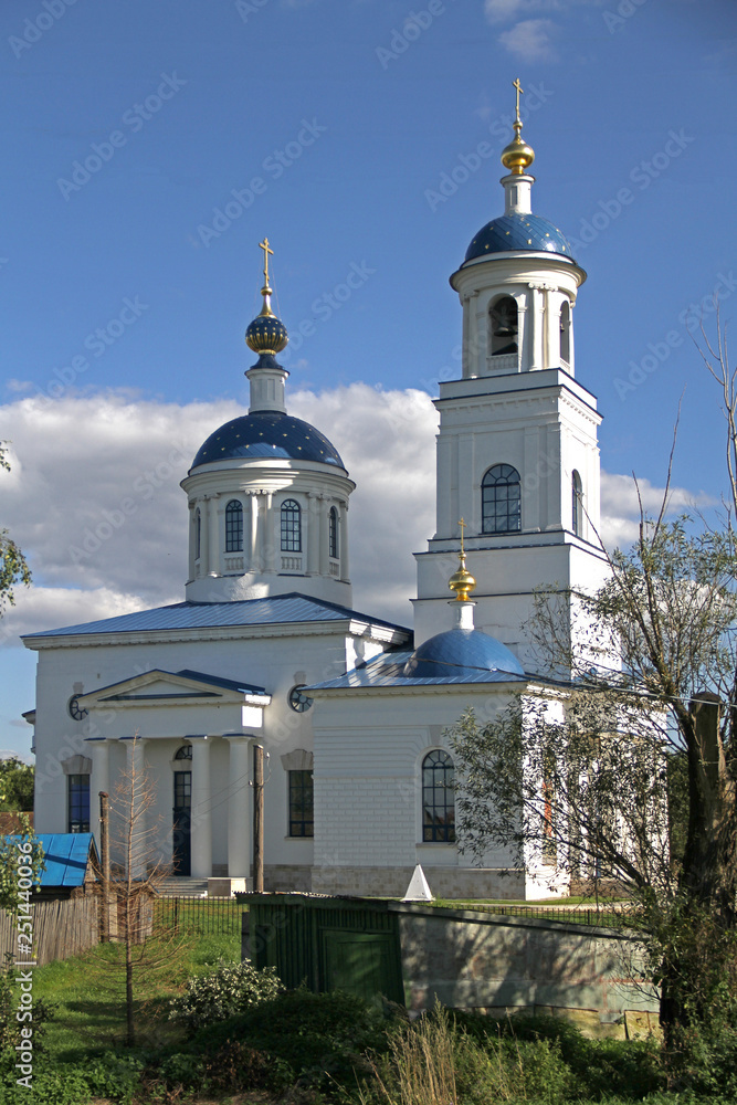 Restored White Stone Orthodox Church with a blue roof and golden domes Restored White Stone Orthodox Church with a blue roof and golden domes
