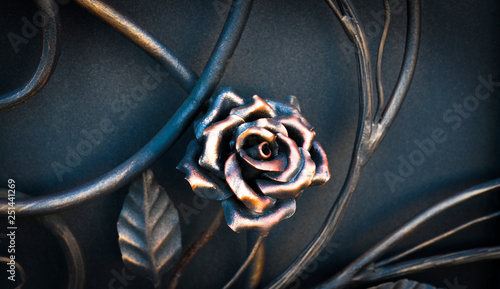 Decorative elements of the fence in the form of metallic flowers