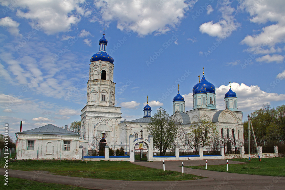 Fototapeta premium Old white stone Orthodox church with blue domes