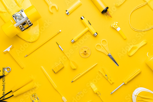 top view of random yellow objects in order on yellow background photo