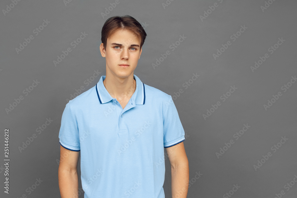 Freestyle. Teenager boy standing isolated on grey looking camera serious Freestyle. Teenager boy standing isolated on grey looking camera serious