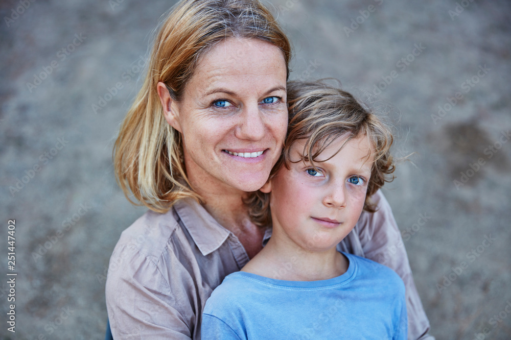 Portrait of smiling mother with son outdoors Portrait of smiling mother with son outdoors