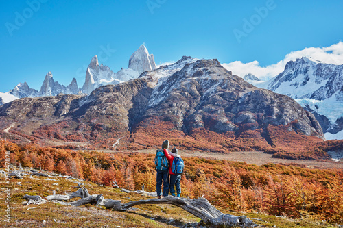 Argentina, Patagonia, El Chalten, two boys on a hiking trip embracing at Fitz Roy massif photo