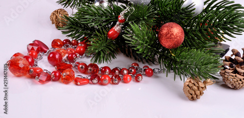 red necklace with red spruce earrings with New Year's ornaments..