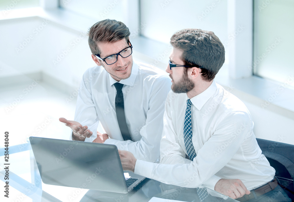 two business colleagues looking at the laptop screen two business colleagues looking at the laptop screen