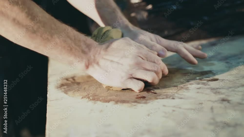View of manly male hands kneading clay dough. 4K View of manly male hands kneading clay dough. 4K