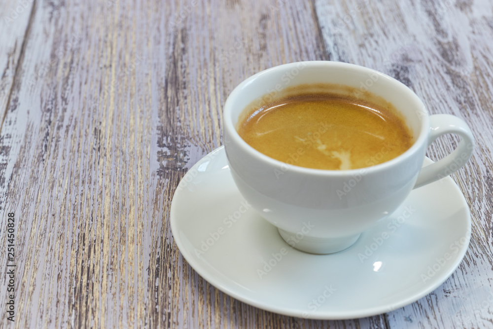 white Cup of coffee on a wooden table close-up. black coffee with milk. wooden table with a fragrant drink. white Cup of coffee on a wooden table close-up. black coffee with milk. wooden table with a fragrant drink.