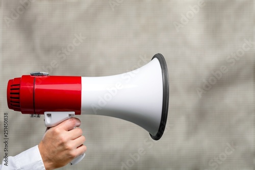 Close-up Human Hand with Megaphone on background