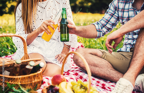 Couple enjoying picnic in the park, close up photo. Love and tenderness, dating, romance, lifestyle concept