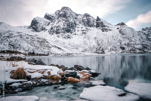 Winter landscape in the Lofoten Islands, snowy mountains and sea