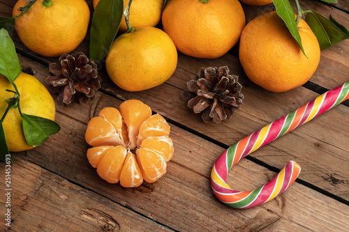 orange tangerines with leaves on a wooden background, new year