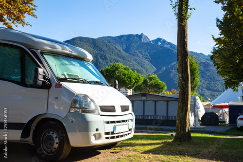 RV standing on a campsite in Ticino / Switzerland with view towards Alps