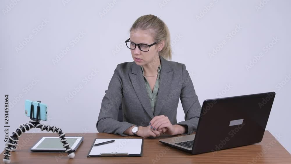 Young beautiful blonde businesswoman vlogging and explaining something at work Young beautiful blonde businesswoman vlogging and explaining something at work