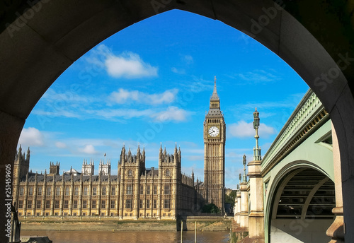 big ben in london framed by the arch of a bridge