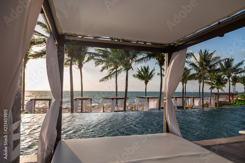 Fotografie, Obraz Private beds in a lounge area of a a high end Mexican resort overlooking the ocean at sunrise
