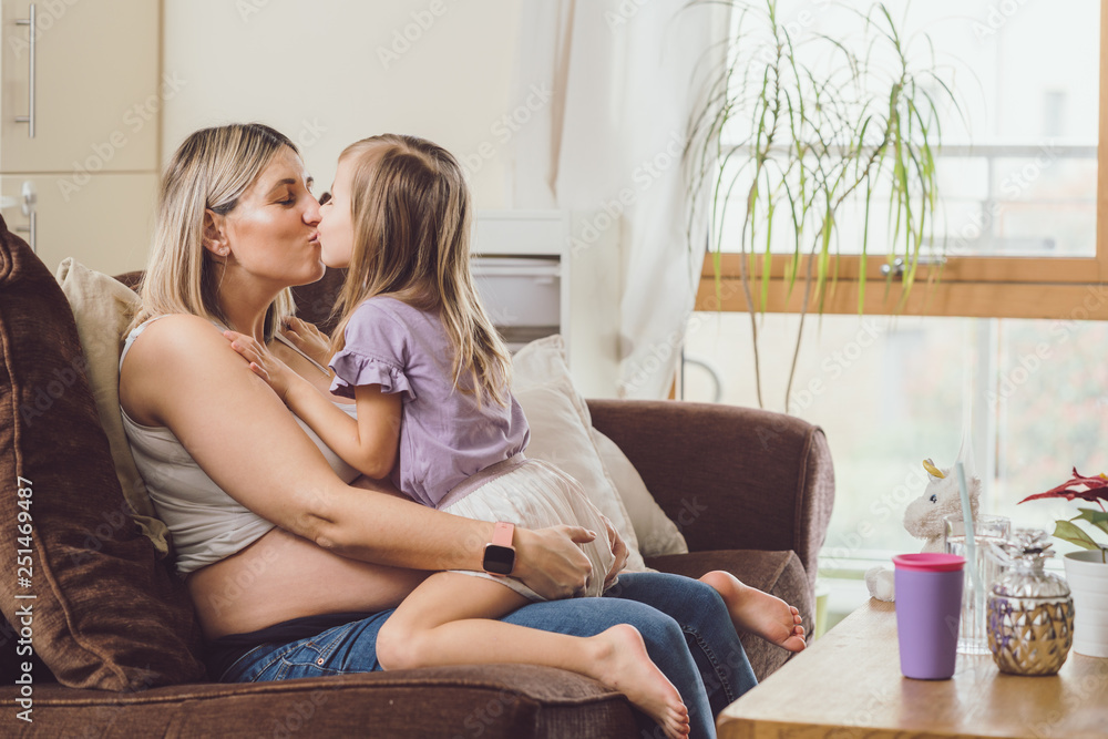 Mother mom daughter girl pregnant living room happiness