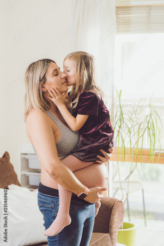 Mother mom daughter girl pregnant living room happiness