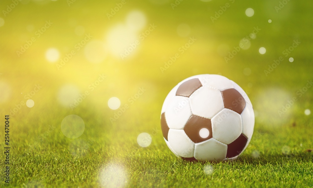 Fototapeta premium Close view of green football field with soccer ball