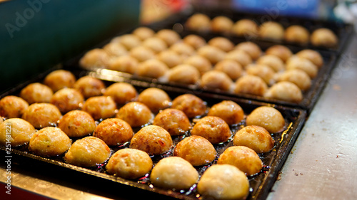 Takoyaki cooking on hot pan