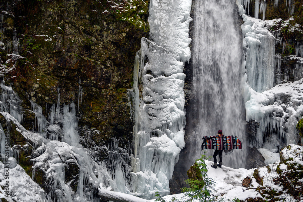 A young woman enjoying the view of Cascade falls regional park in Deroche, British Columbia A young woman enjoying the view of Cascade falls regional park in Deroche, British Columbia