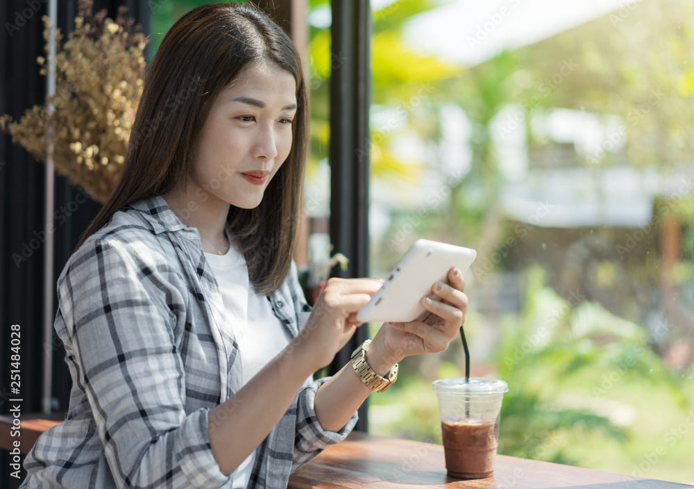 happy woman using digital tablet in cafe happy woman using digital tablet in cafe