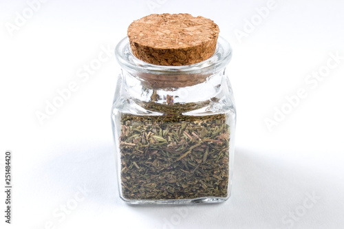thyme herb in a glass jar isolated on white background
