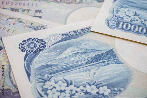 Close up macro of mount Fuji or Fuji san on 1000 Japanese yen banknote texture background. Concept of Japanese yen payment currency of Japan. Forex investment, stock market or Travel holiday in Japan. photo