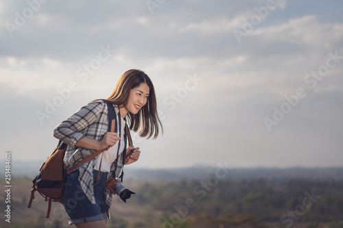 female tourist with backpack and camera in countryside