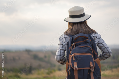 female tourist with backpack in countryside