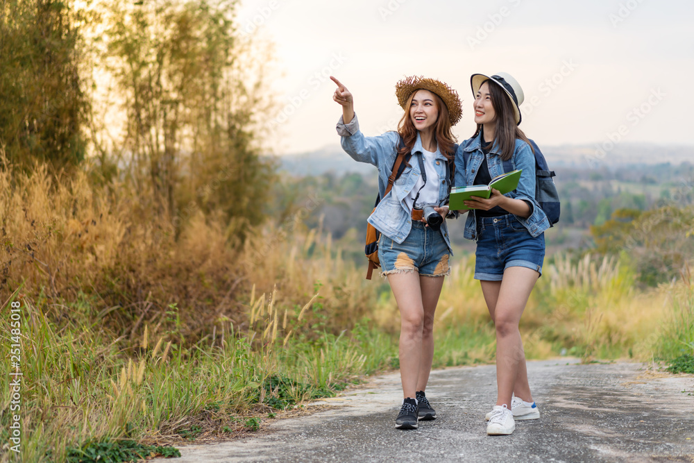 Fototapeta premium two woman searching direction on location map while traveling