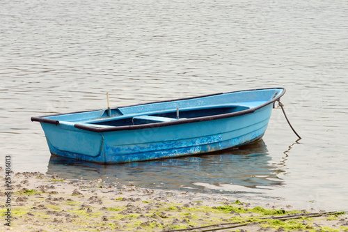 fishing wooden boat moored in the sea